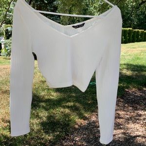 Cropped white ribbed long sleeve top